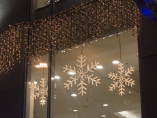 Decorative lighting of store windows using twinkle lights, icicle lights and other lighting elements